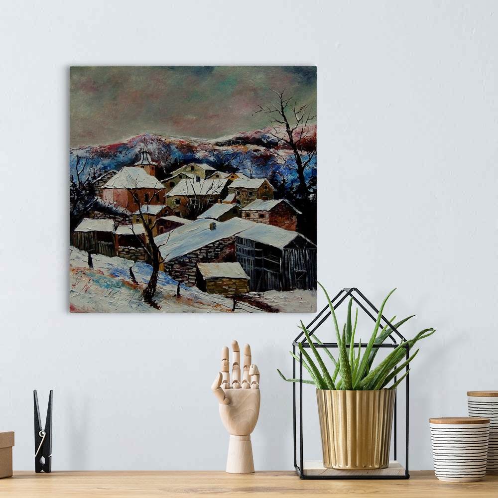 A bohemian room featuring A vertical painting of a snow over village of Laforet, Belgium.