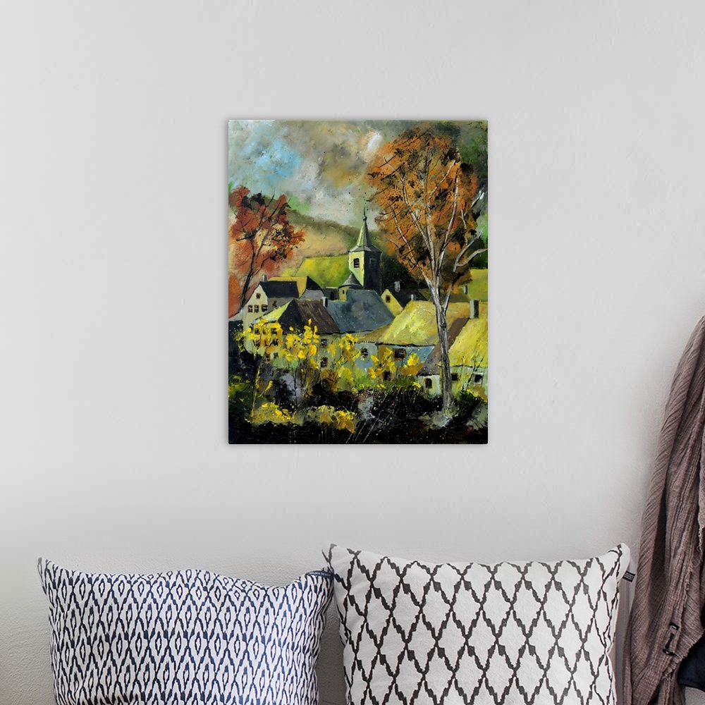 A bohemian room featuring Vertical painting of a darkened landscape with trees in the foreground and a Belgium village in t...