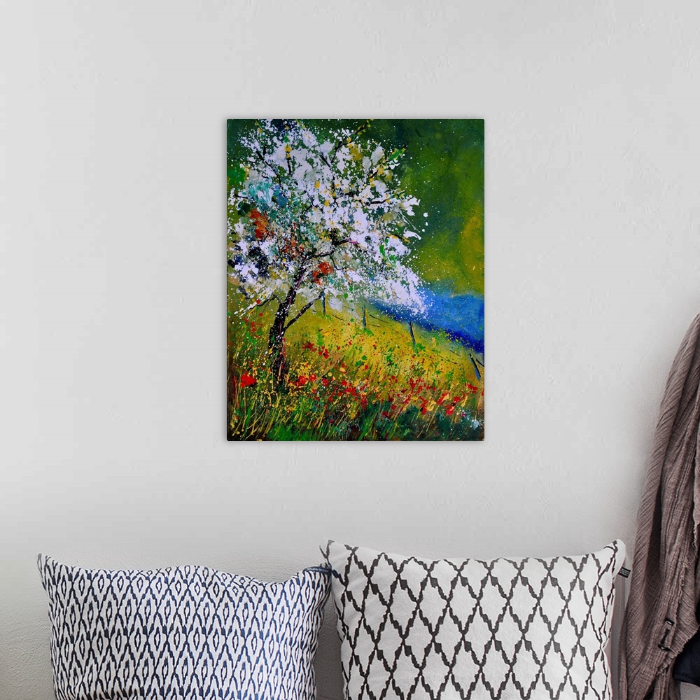 A bohemian room featuring Vertical painting of a tree covered in white blooming flowers along a field of wild flowers on a ...