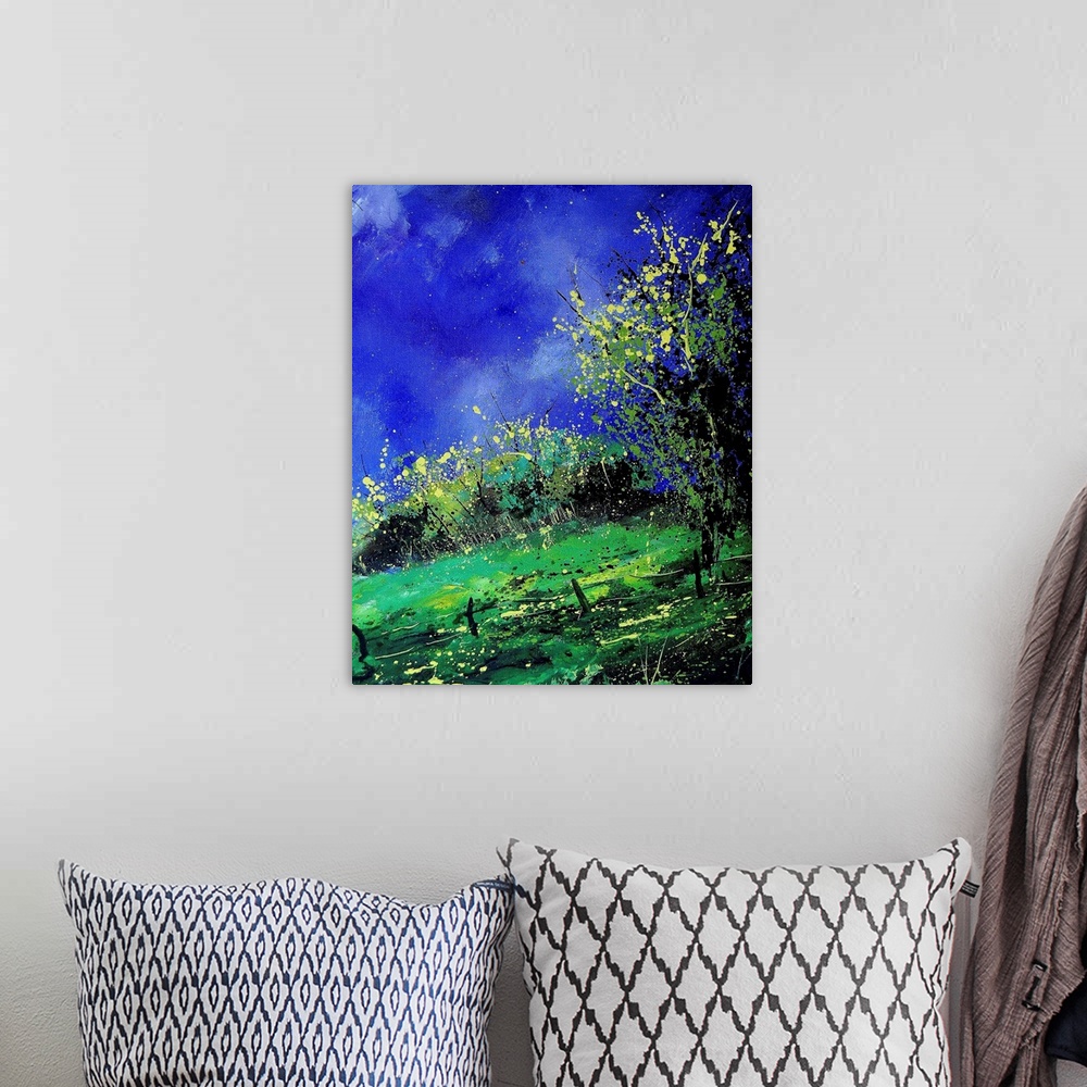 A bohemian room featuring A vertical painting of a fenced in field with a brilliant blue sky.