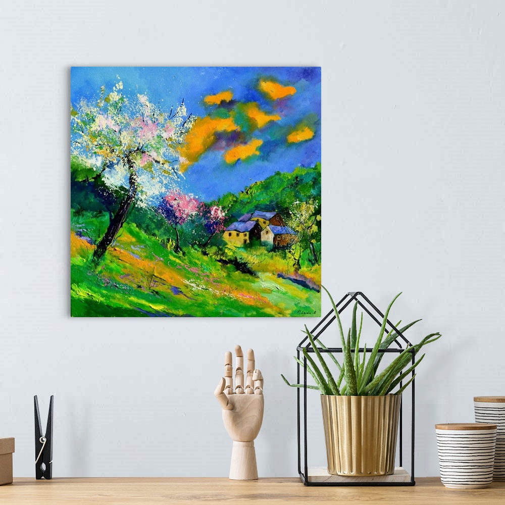 A bohemian room featuring Vibrant painting of a bright Summer day with blossoming trees, a colorful sky, and a village in t...