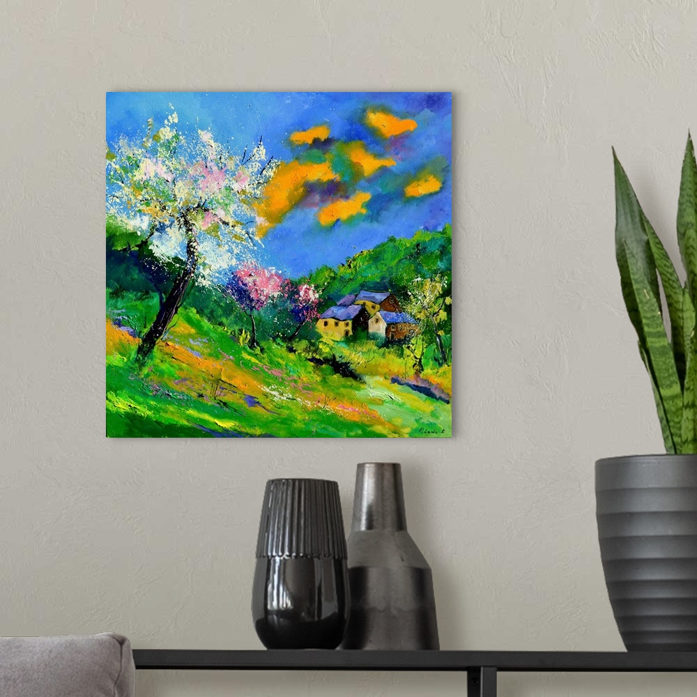 A modern room featuring Vibrant painting of a bright Summer day with blossoming trees, a colorful sky, and a village in t...