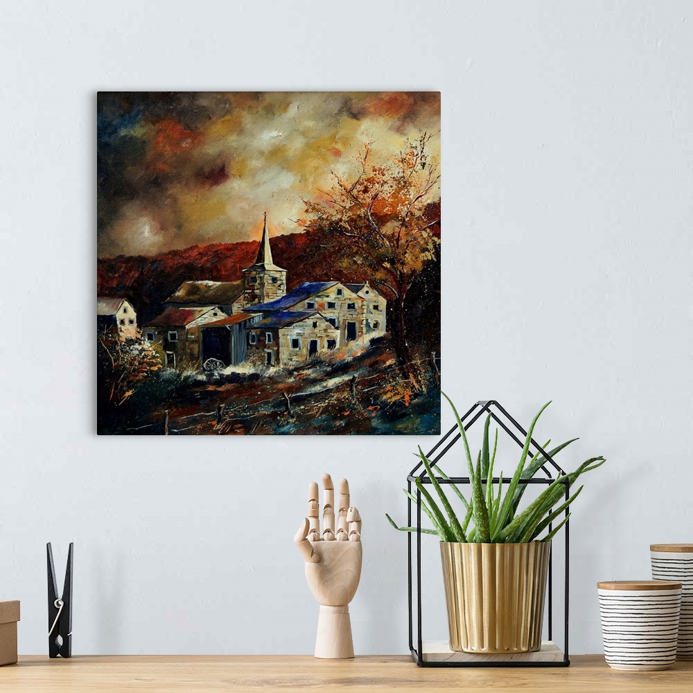 A bohemian room featuring Vertical painting of a darkened landscape with a field in the foreground and a Belgium village in...
