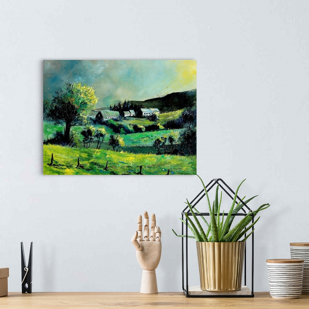 A bohemian room featuring Horizontal painting of a spring landscape with rolling fields in the foreground and a Belgium vil...