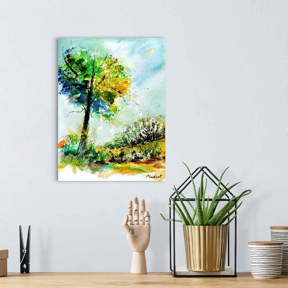 A bohemian room featuring A vertical watercolor landscape of a tree with vibrant speckled colors of yellow, green and blue.