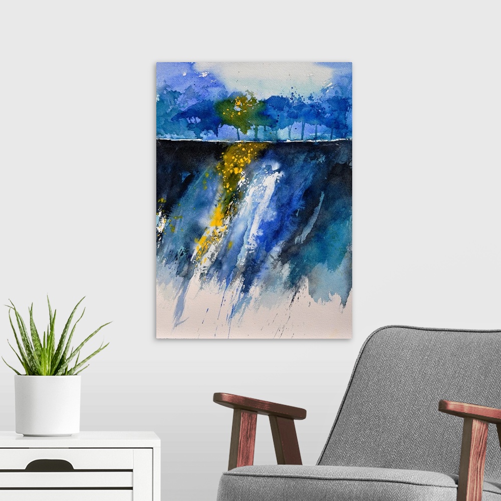 A modern room featuring A vertical watercolor landscape in varies shades of blue with yellow accents.
