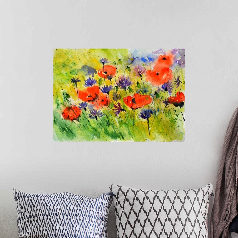 A bohemian room featuring Horizontal watercolor painting of bright red poppies and purple flowers in a field.