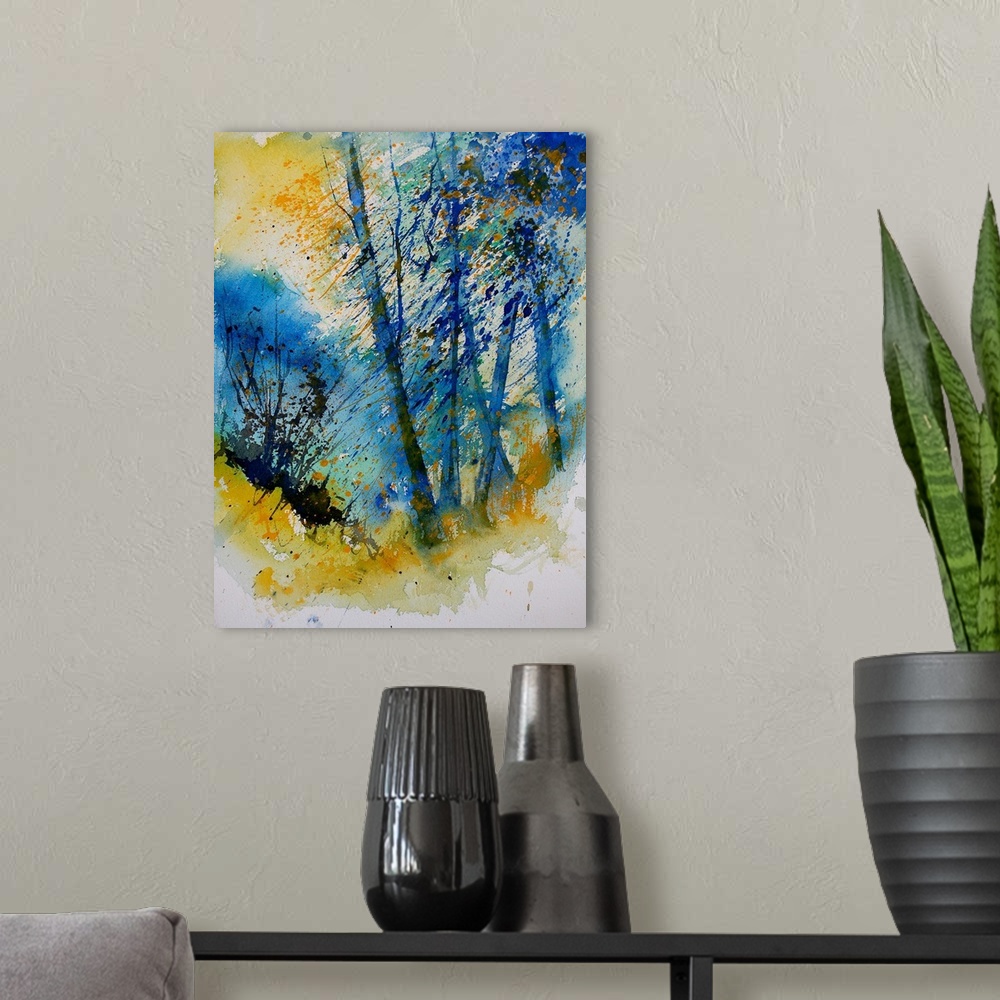 A modern room featuring A vertical watercolor landscape of trees in bright colors of yellow and blue.