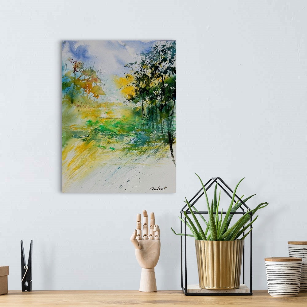 A bohemian room featuring A vertical watercolor landscape in bright colors of yellow, green and blue.