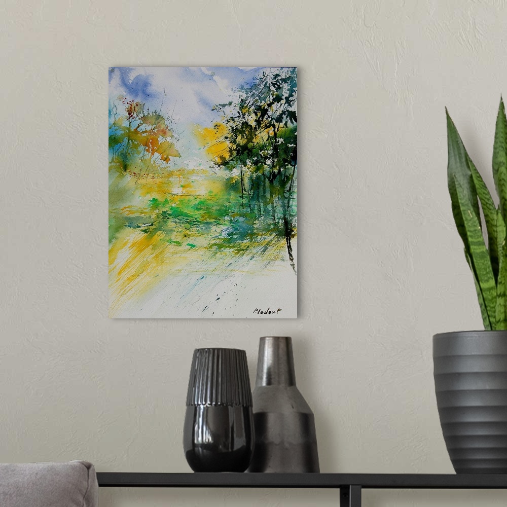 A modern room featuring A vertical watercolor landscape in bright colors of yellow, green and blue.