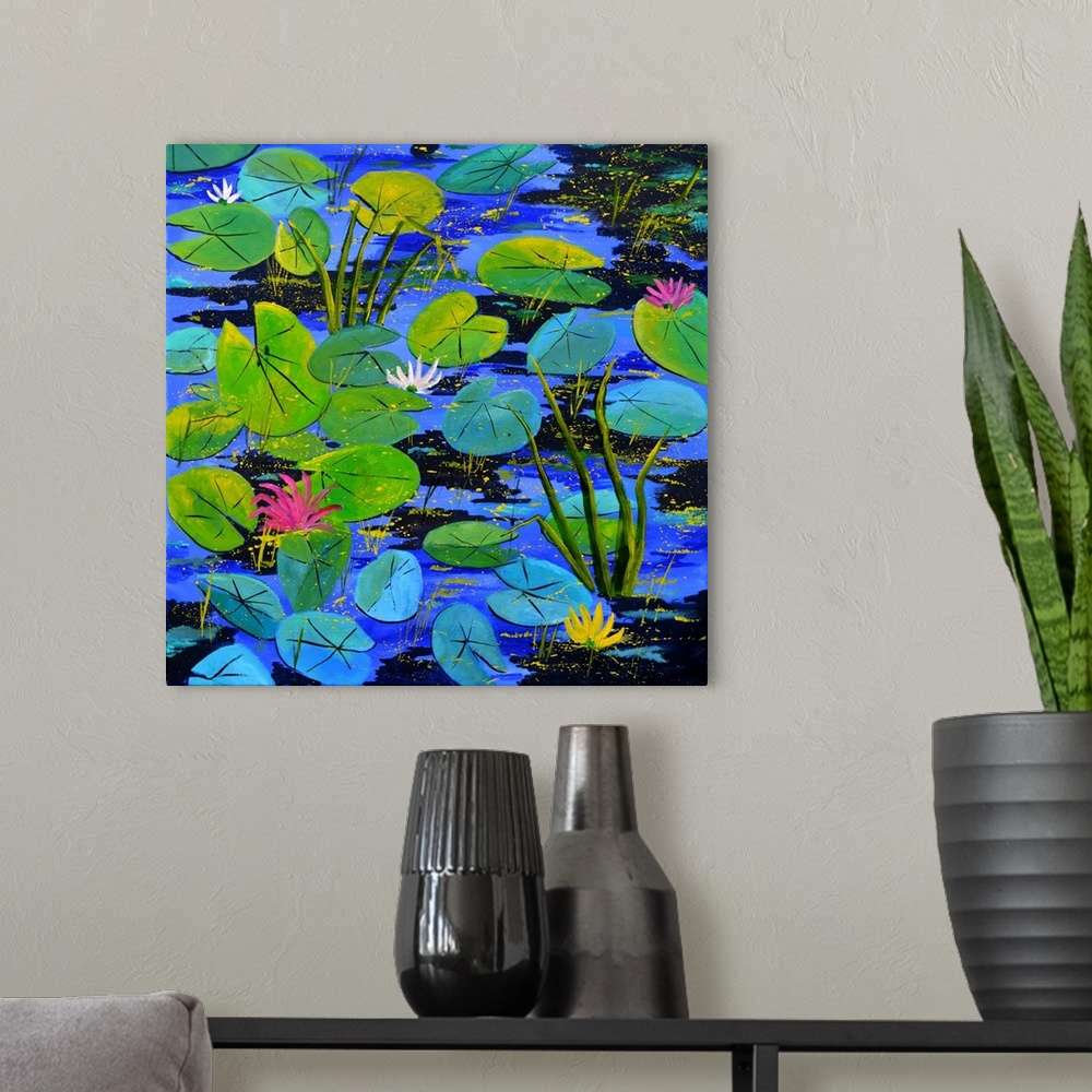 A modern room featuring Square painting of blue and green water lilies with flower blooms and small speckles of paint ove...