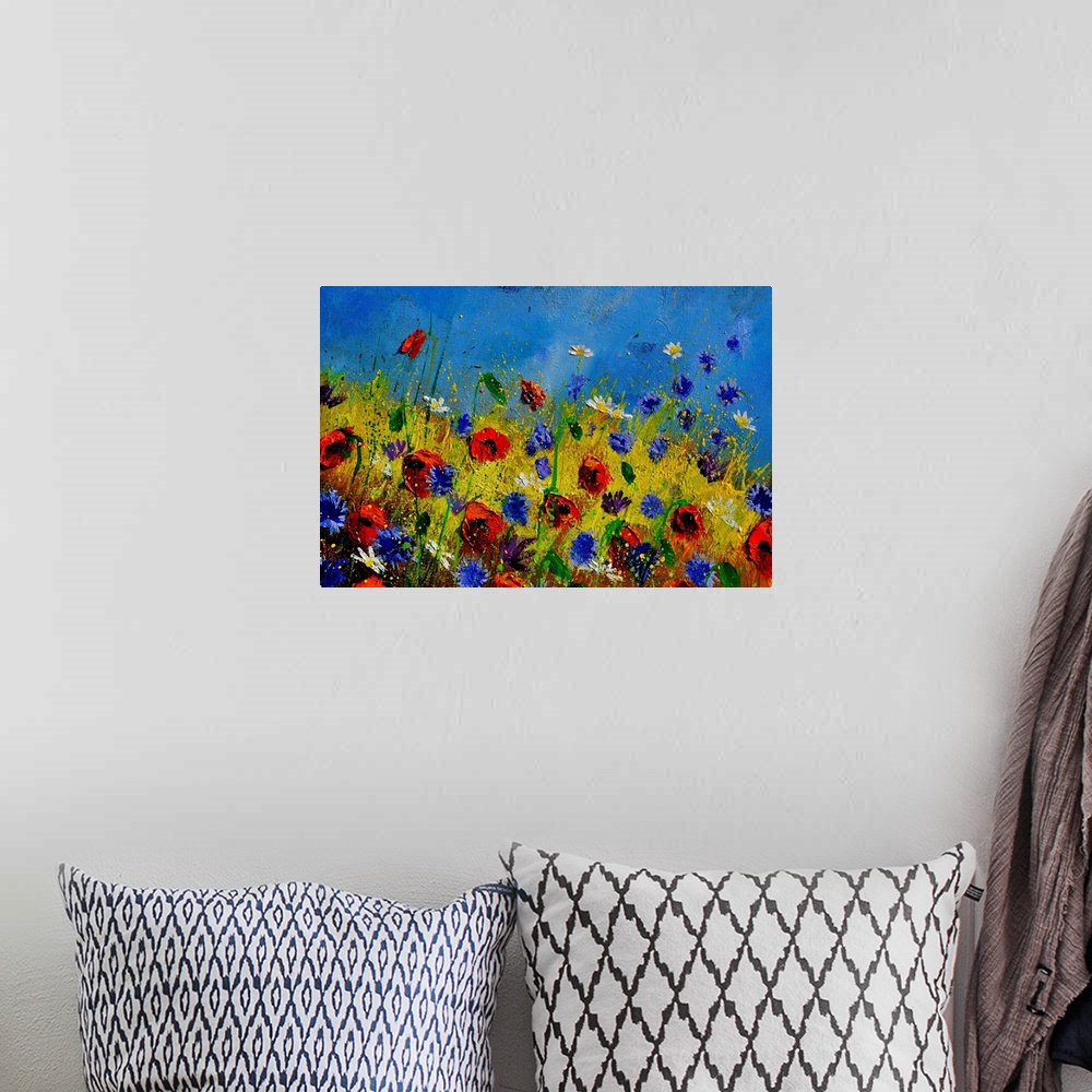 A bohemian room featuring Horizontal painting of colorful flowers in a field and a bright blue sky with small speckles of p...