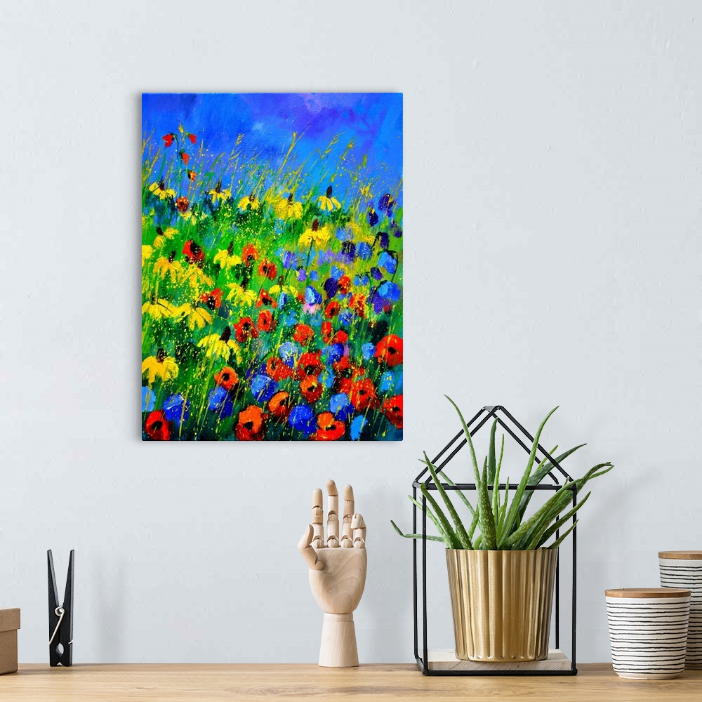 A bohemian room featuring Vertical painting of a a field of colorful wild flowers and a bright blue sky with small speckles...