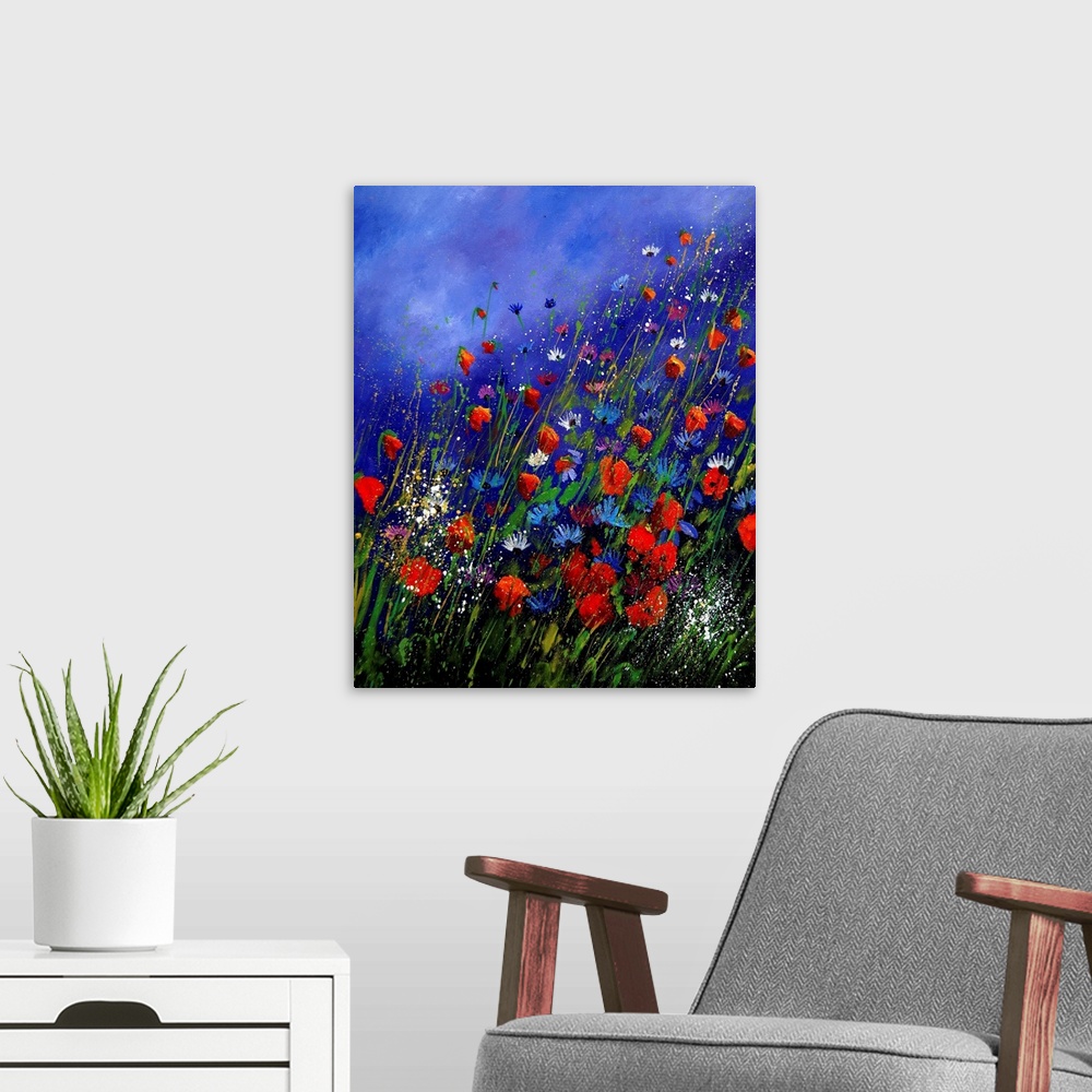 A modern room featuring Vertical painting of a field of red and blue wild flowers in bloom with a vibrant blue sky.
