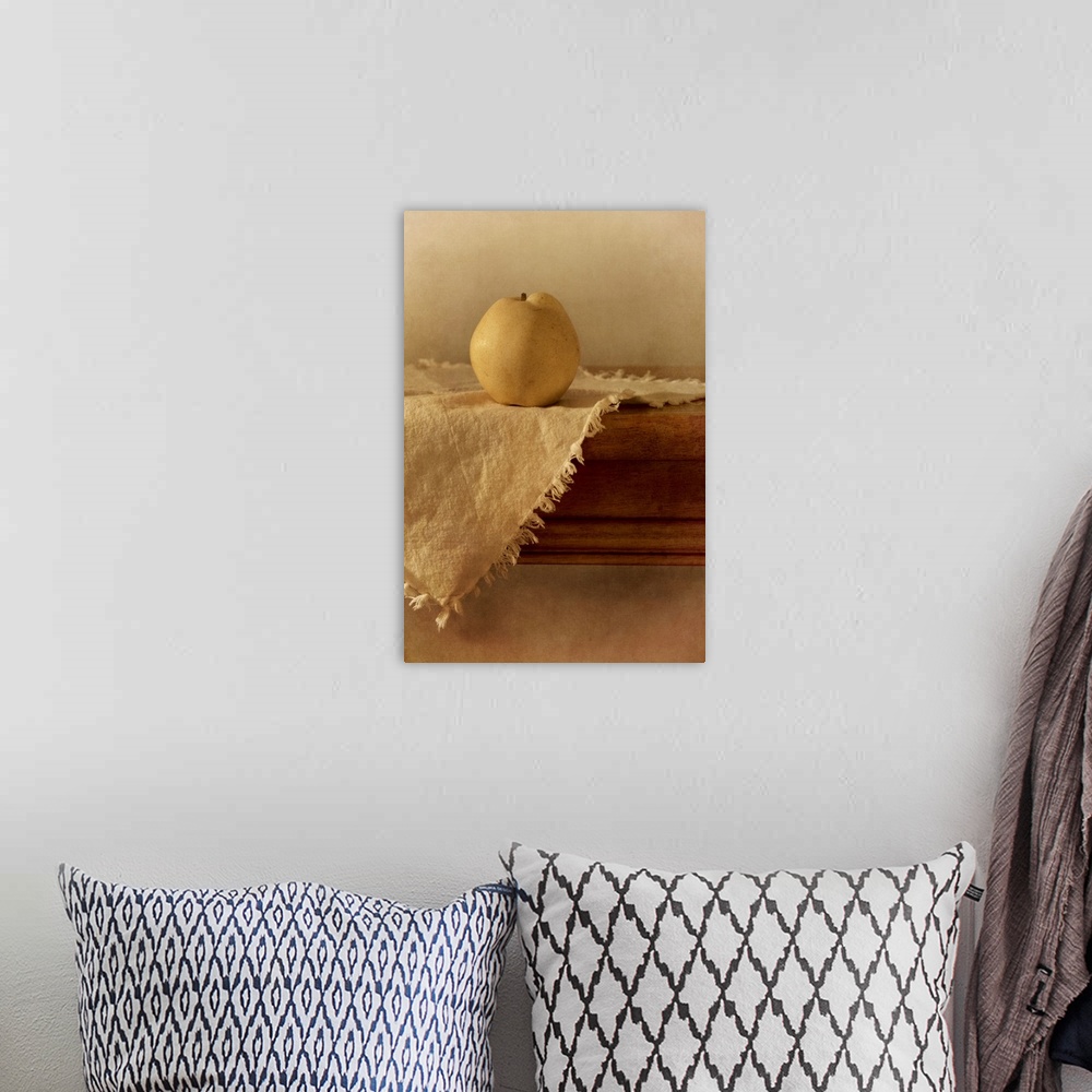 A bohemian room featuring A single apple pear on a wooden table