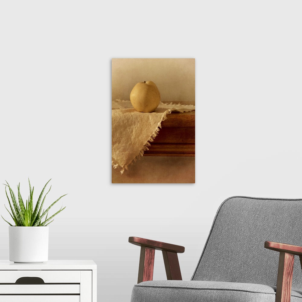 A modern room featuring A single apple pear on a wooden table