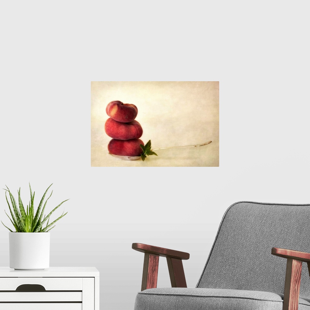 A modern room featuring Balancing act with vineyard peaches and some peppermint leaves on a tablespoon