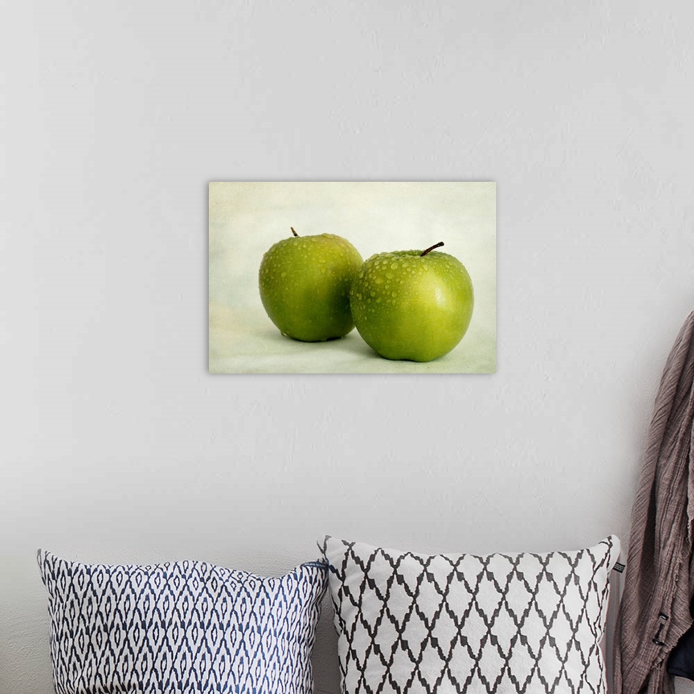 A bohemian room featuring Two apples with water drops, taken with available light
