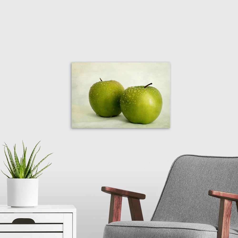 A modern room featuring Two apples with water drops, taken with available light