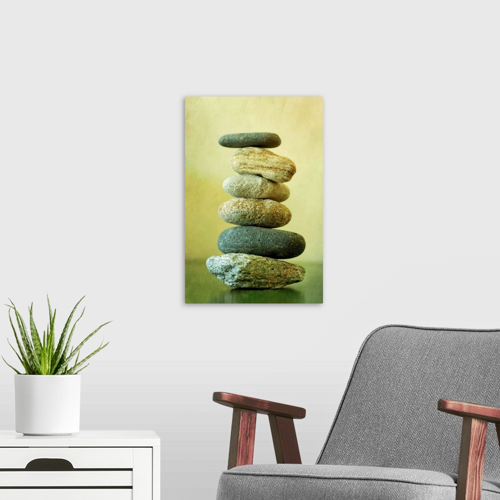 A modern room featuring Large vertical piece showing stones that have been stacked on top of each other that decrease in ...