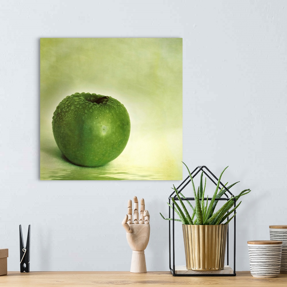 A bohemian room featuring Green apple with water drops and reflection in the water
