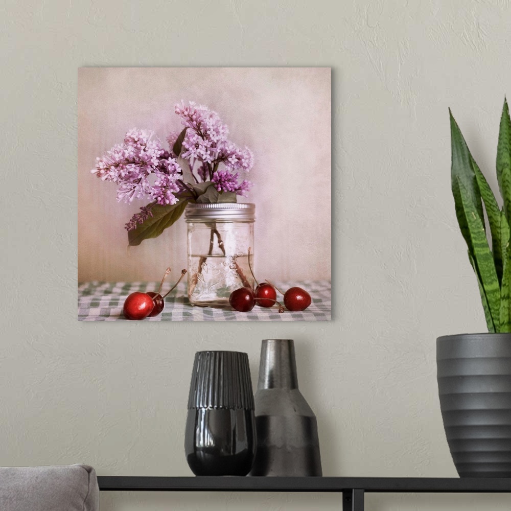 A modern room featuring A still life, with lilac blossoms and red cherries