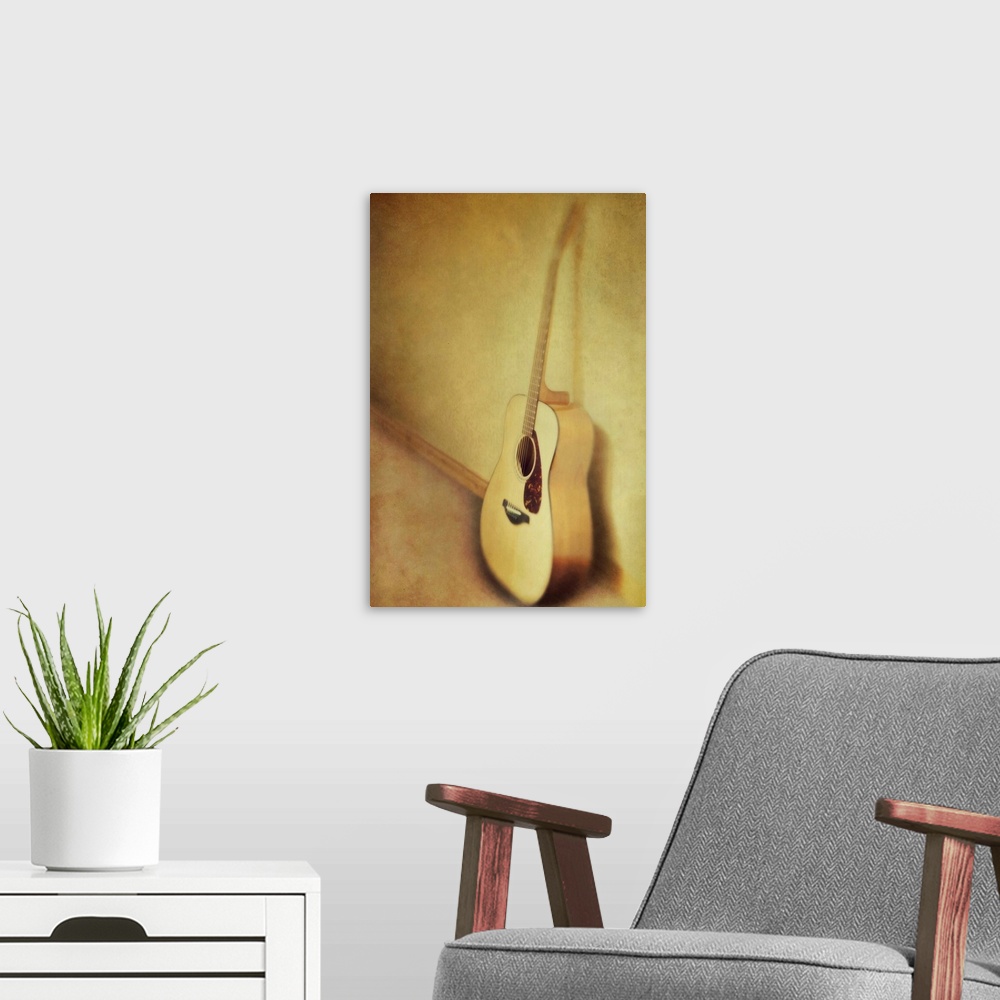 A modern room featuring Guitar leaning a against a wall.