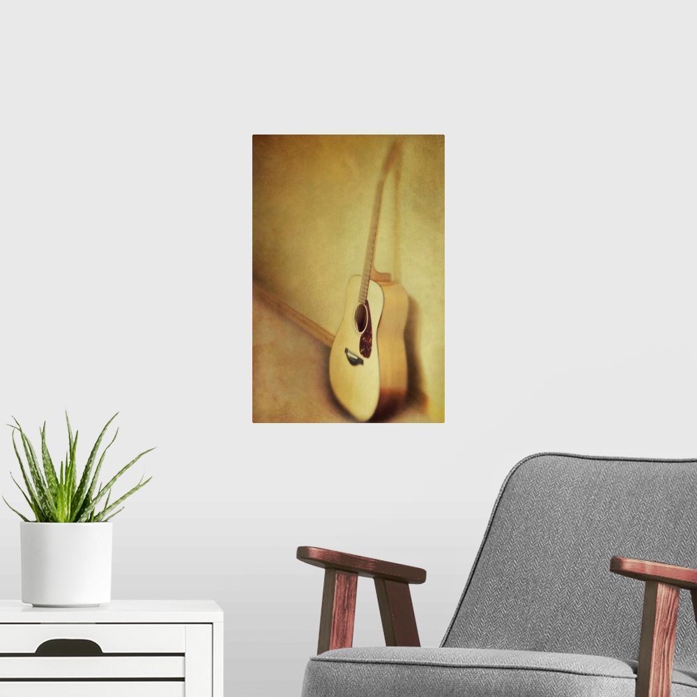 A modern room featuring Guitar leaning a against a wall.