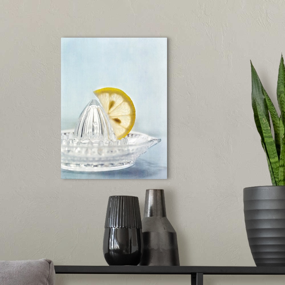 A modern room featuring Simple, clean, still life with a slice of a lemon on a squeezer