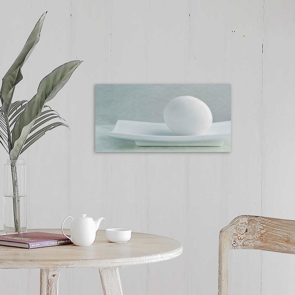 A farmhouse room featuring Simple, soft still life with a white chicken egg in a white dish