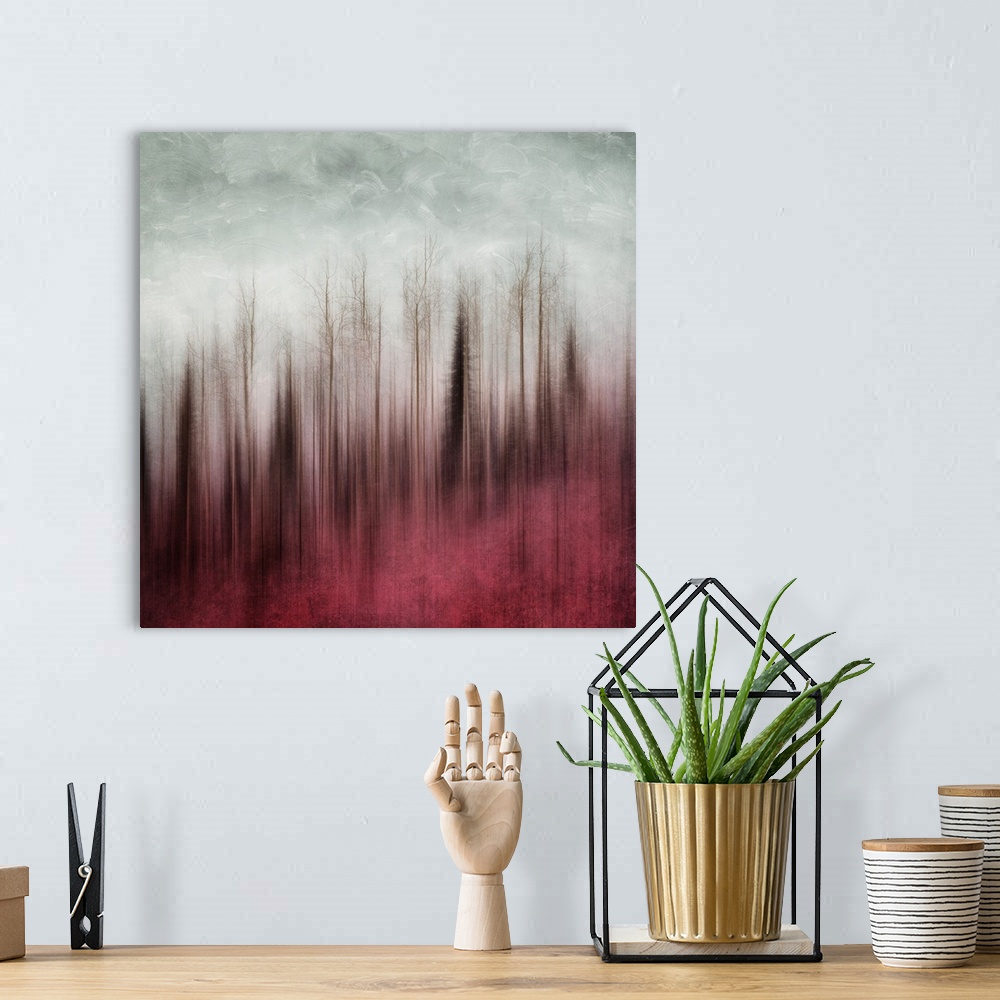 A bohemian room featuring An artistic photograph of a blurred forest in red tones under a gray sky.
