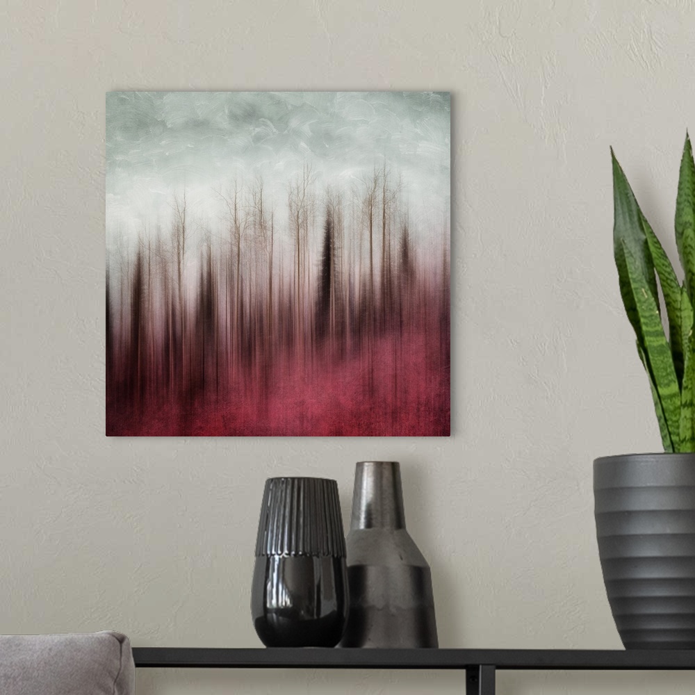 A modern room featuring An artistic photograph of a blurred forest in red tones under a gray sky.