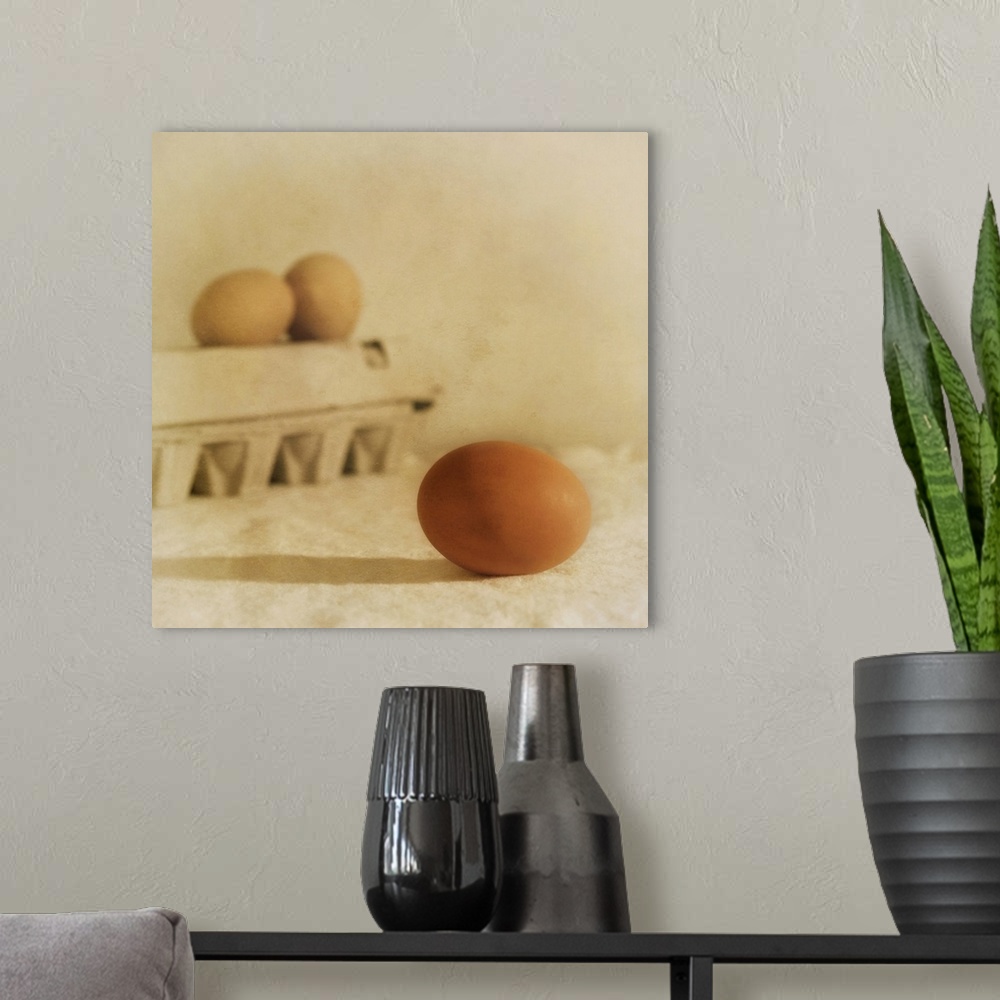 A modern room featuring Three eggs, one in the foreground, taken with a shallow depth of field