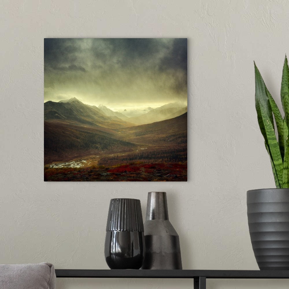 A modern room featuring An artistic photograph of a mountain valley under a dark sky.