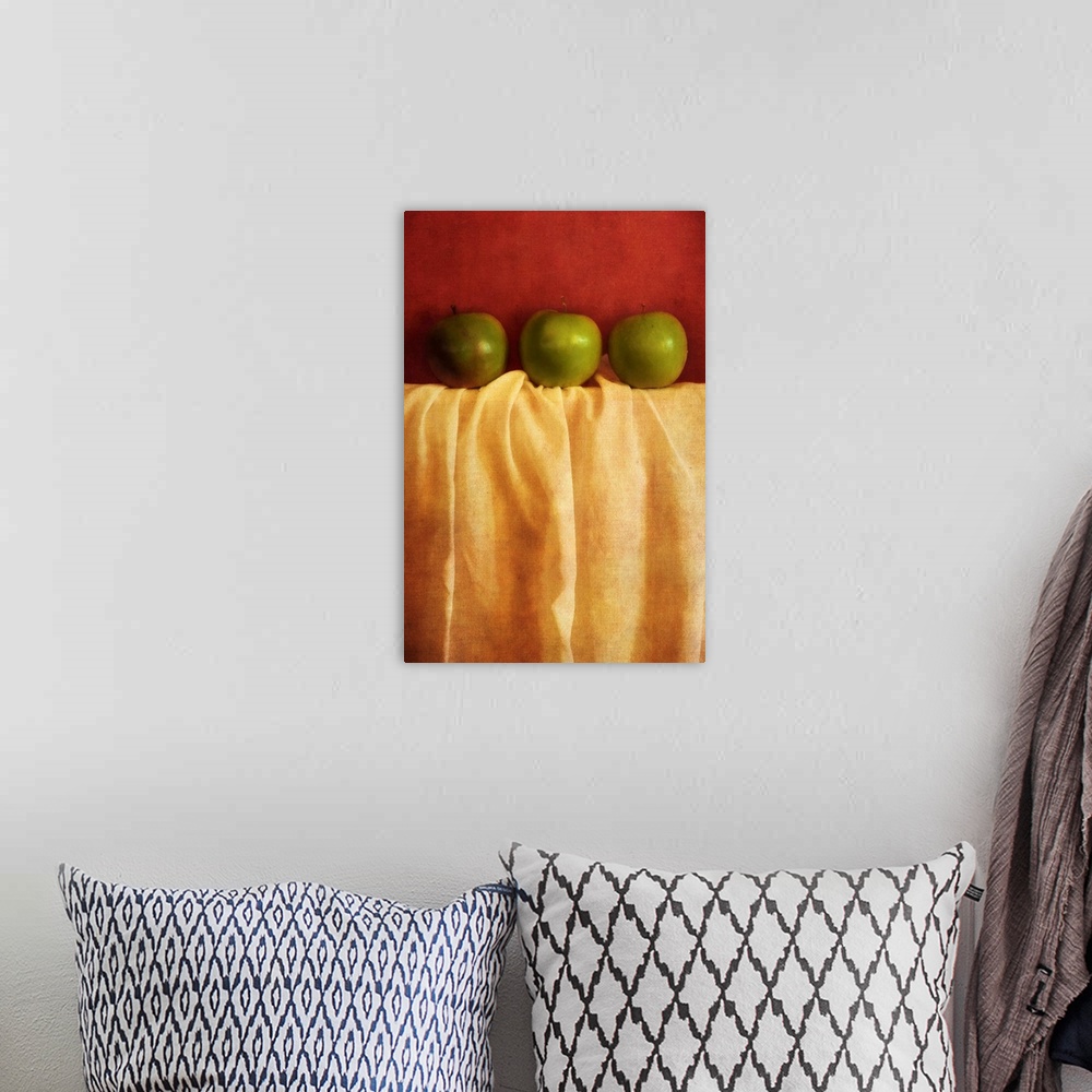 A bohemian room featuring Still life with three granny smith apples against red background