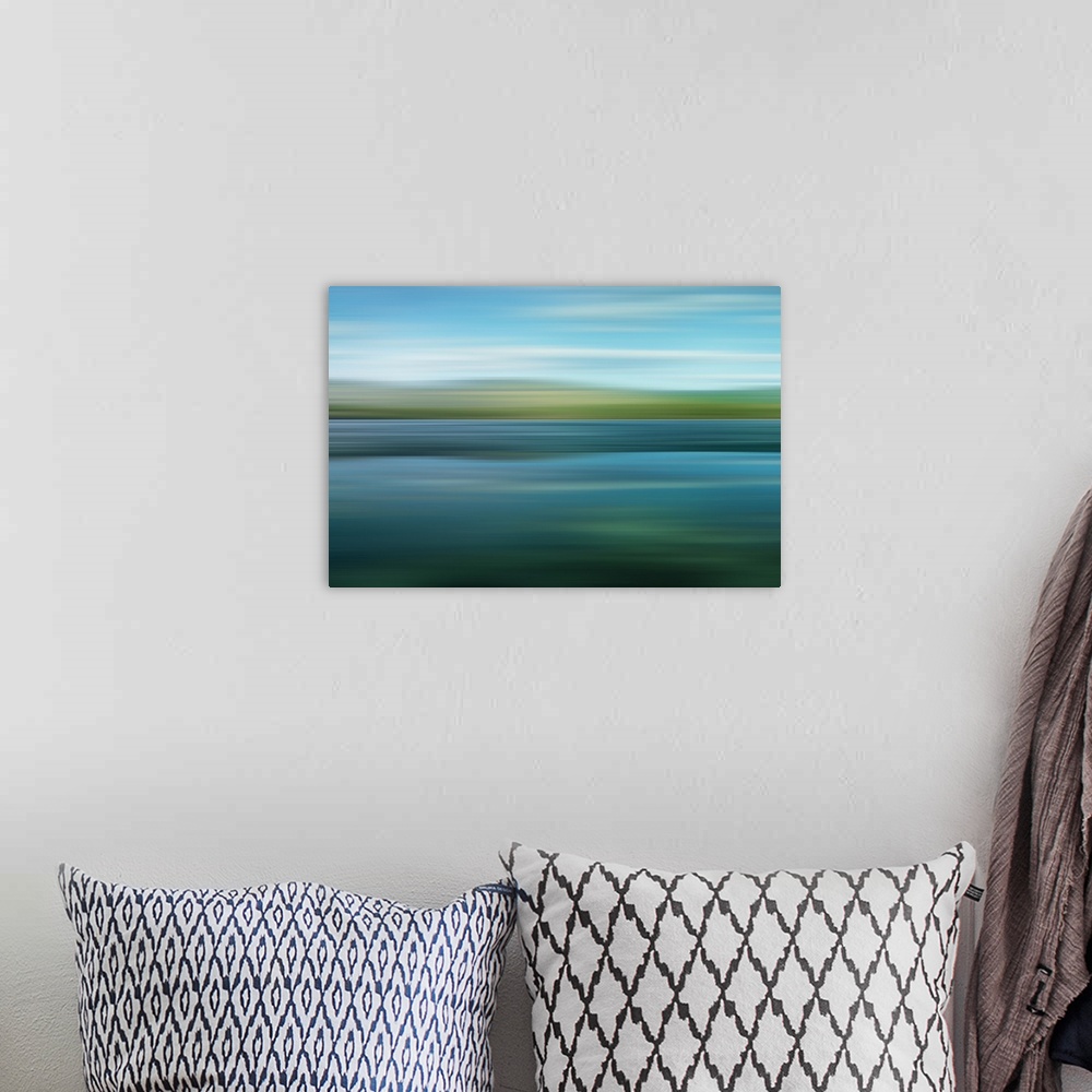 A bohemian room featuring An artistic photograph of a horizontal blurred landscape of a green mountainscape.