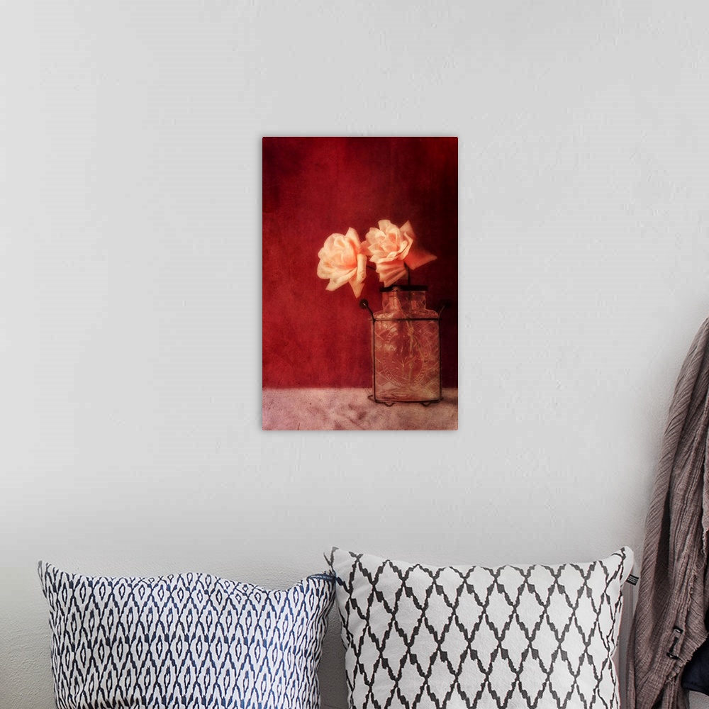 A bohemian room featuring Still life with roses and an old vase against a rich dark red wall, natural light from the window.