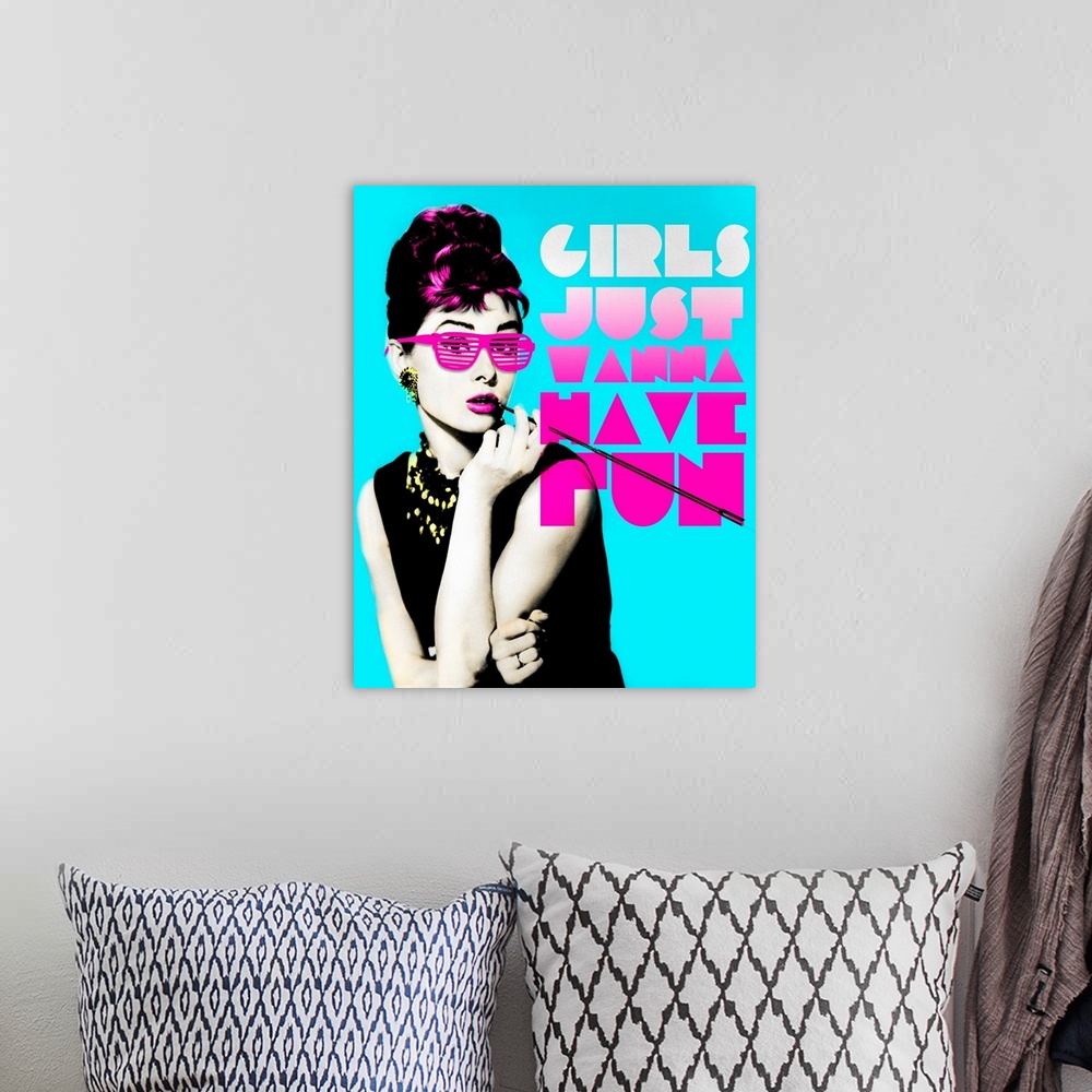 A bohemian room featuring Wall art of Audrey Hepburn wearing sunglasses with the text, ""Girl's just wanna have fun"".