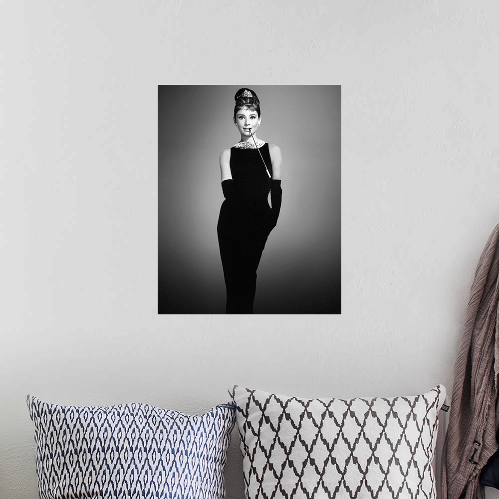 A bohemian room featuring Audrey Hepburn in her classic "Breakfast at Tiffany's" outfit on a soft background.