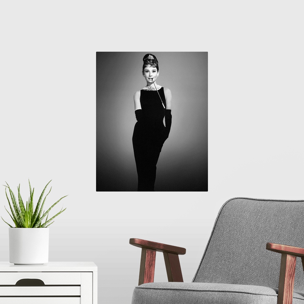 A modern room featuring Audrey Hepburn in her classic "Breakfast at Tiffany's" outfit on a soft background.