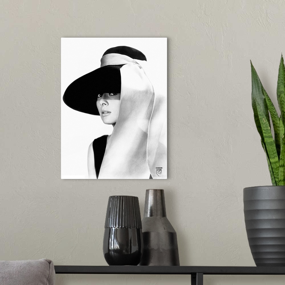 A modern room featuring Black and white photo of Audrey Hepburn in a black dress and large floppy black hat with a white ...