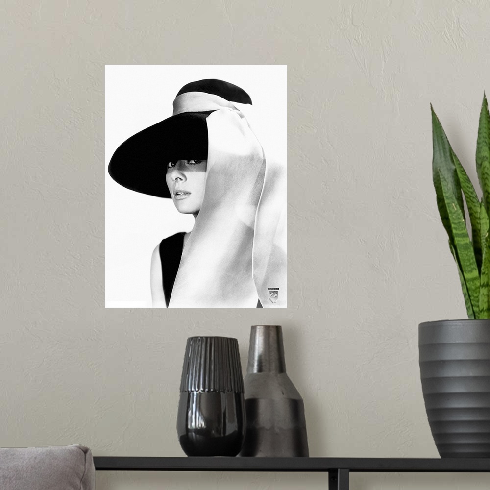 A modern room featuring Black and white photo of Audrey Hepburn in a black dress and large floppy black hat with a white ...