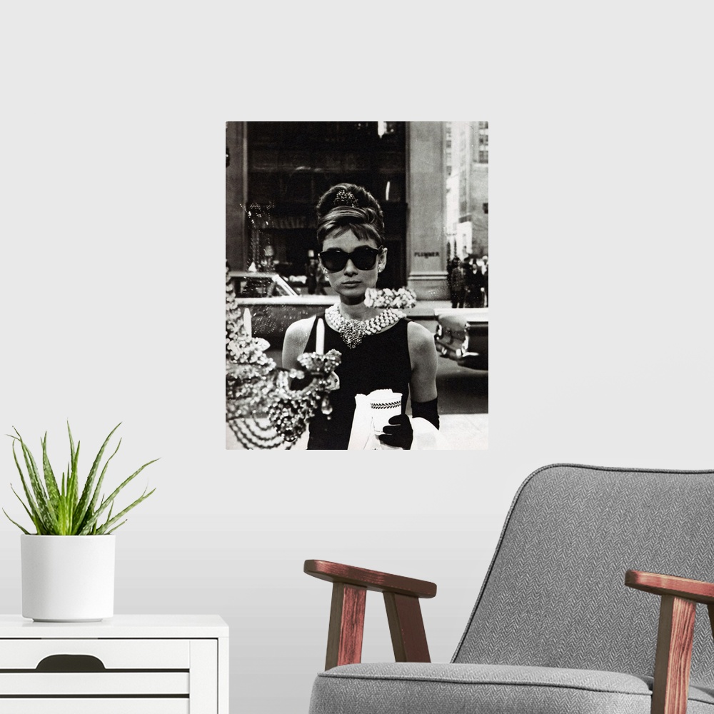 A modern room featuring Movie still of the actress Audrey Hepburn wearing an elegant black dress and extravagant jewelry ...