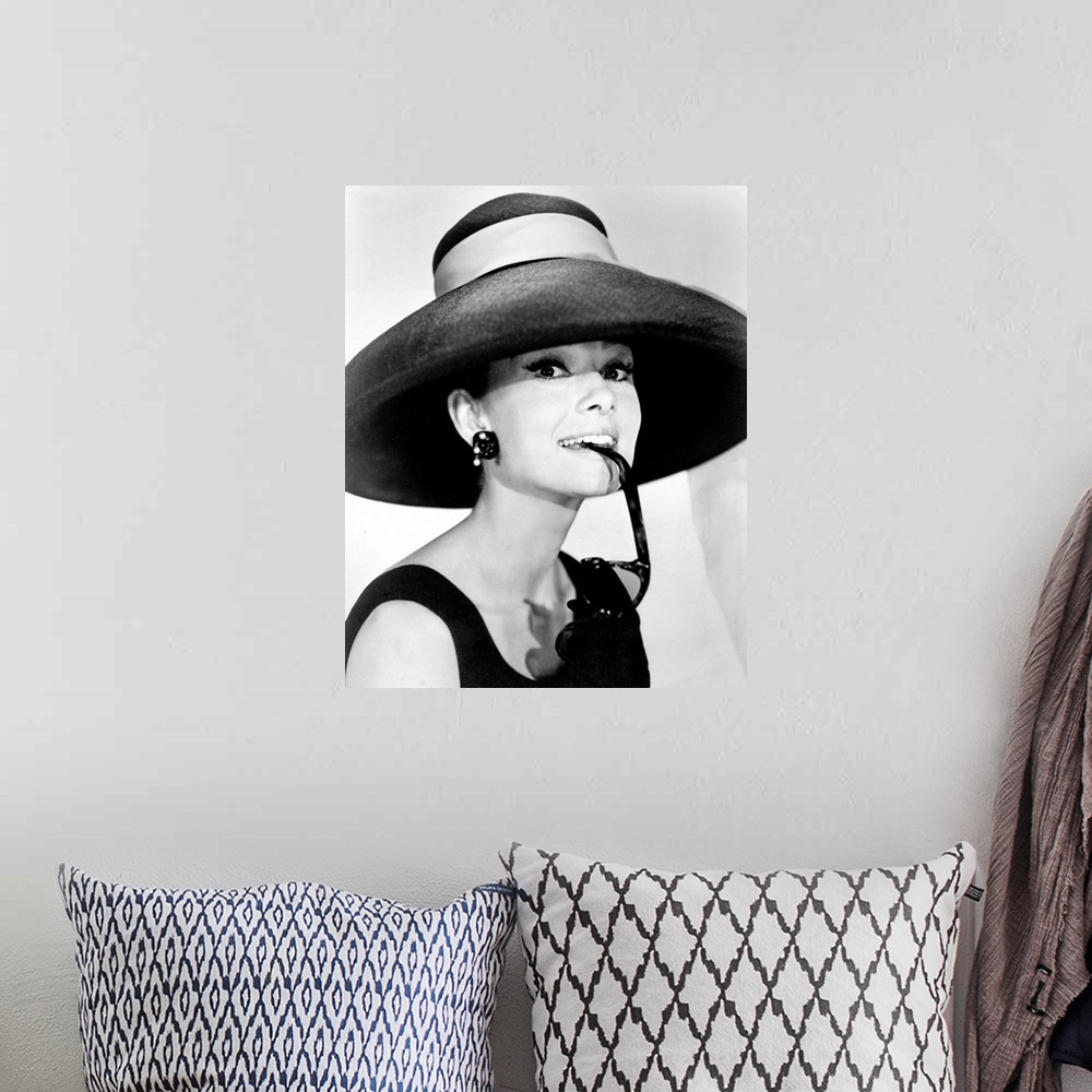 A bohemian room featuring Large photograph of Audrey Hepburn in a giant sun hat holding sunglasses in her mouth as she glan...