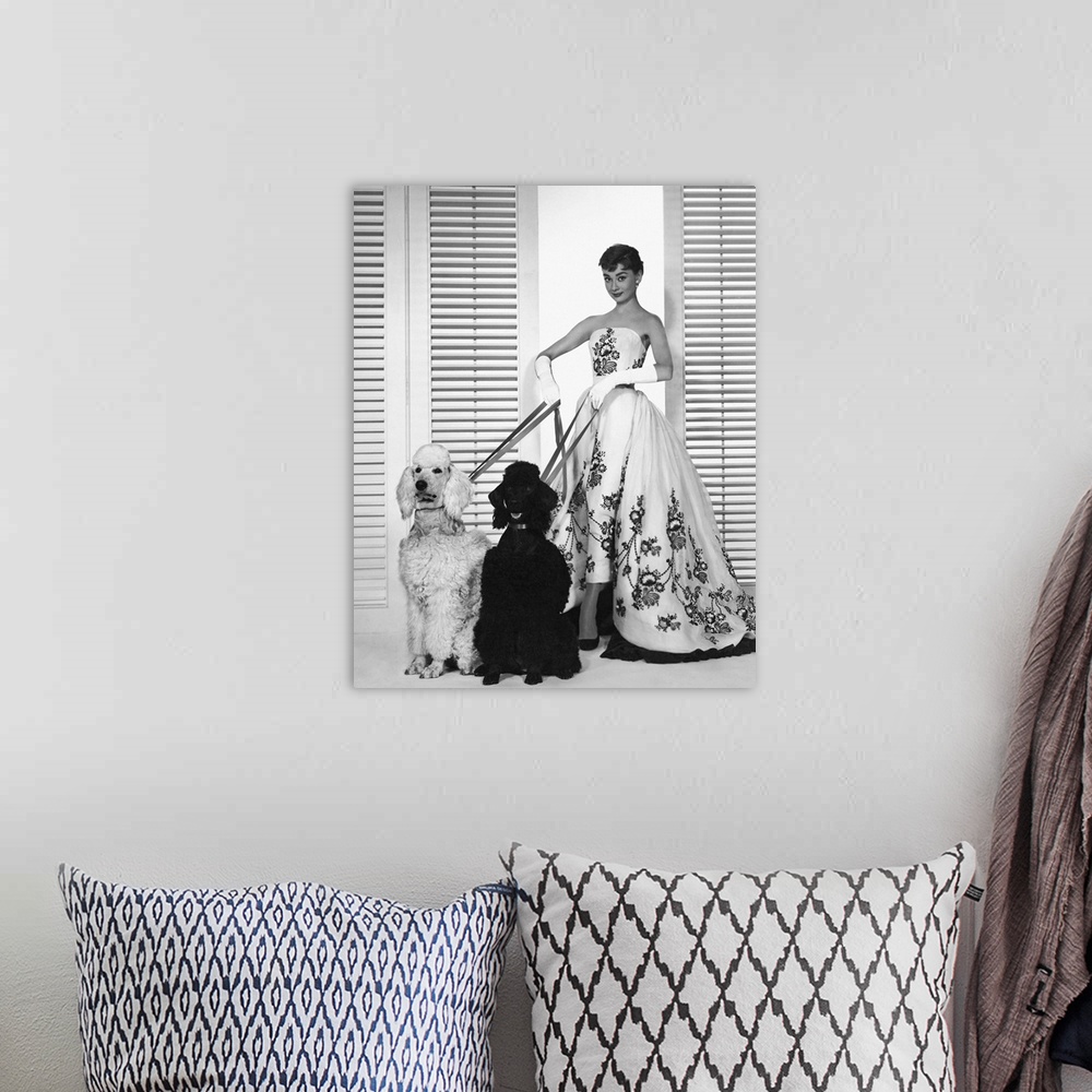 A bohemian room featuring Wall art of Audrey Hepburn holding the leashes of two dogs.