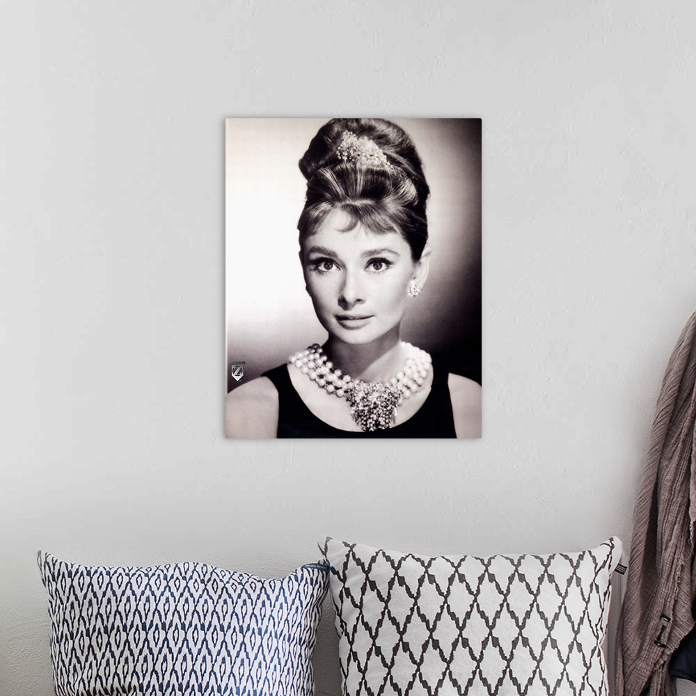 A bohemian room featuring Wall docor of a portrait of Audrey Hepburn in black and white.