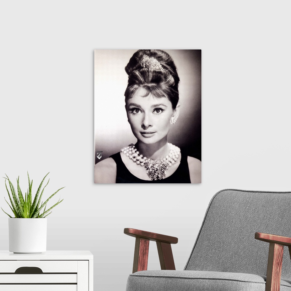 A modern room featuring Wall docor of a portrait of Audrey Hepburn in black and white.