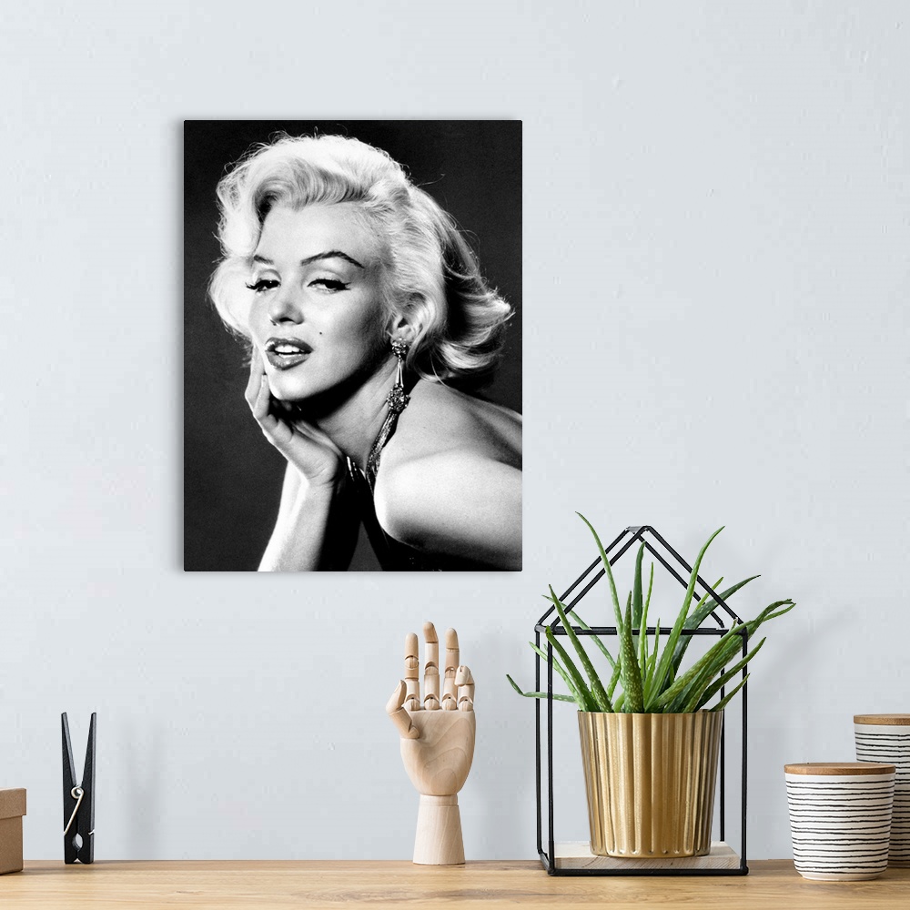 A bohemian room featuring Large, portrait, black and white photograph of Marilyn Monroe, leaning forward with her palm on h...