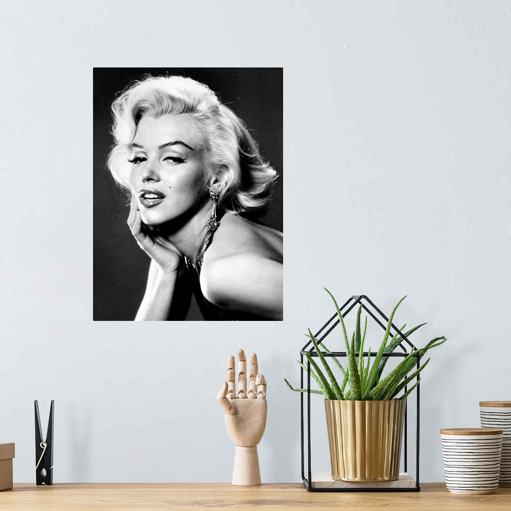 A bohemian room featuring Large, portrait, black and white photograph of Marilyn Monroe, leaning forward with her palm on h...