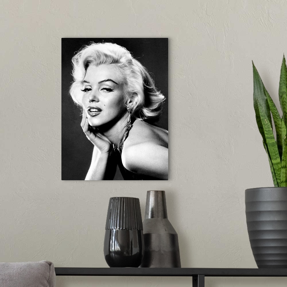 A modern room featuring Large, portrait, black and white photograph of Marilyn Monroe, leaning forward with her palm on h...